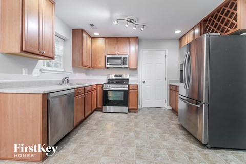 a kitchen with wooden cabinets and stainless steel appliances