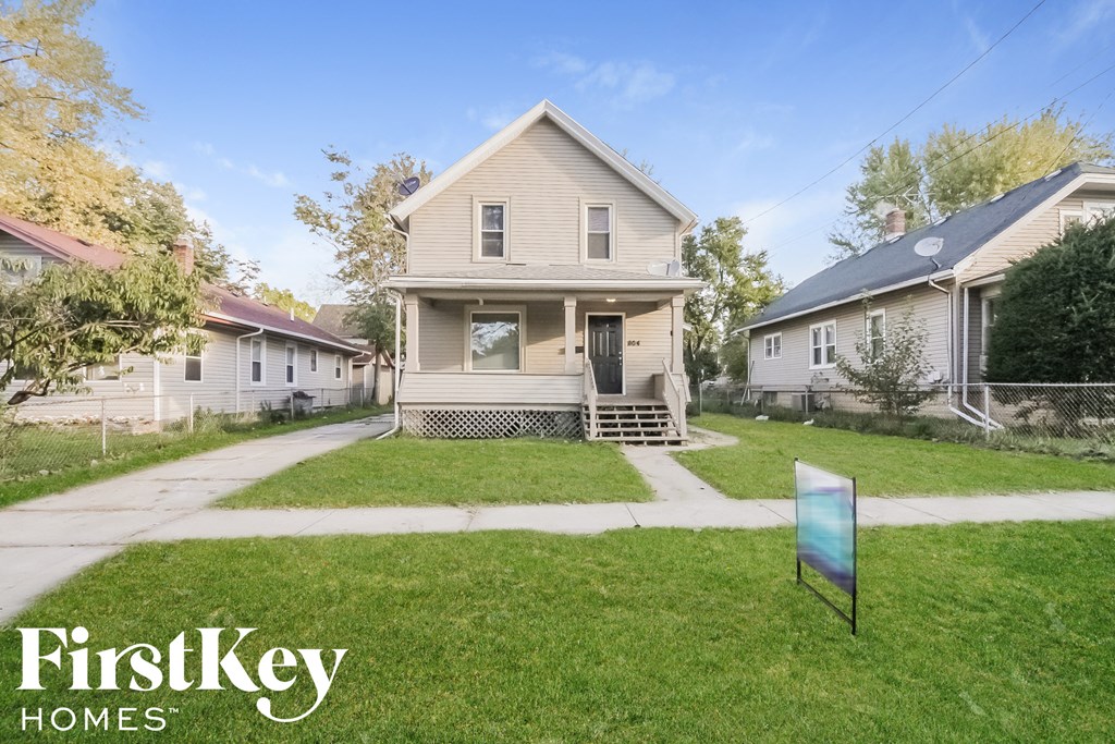 A house with a sign that says FirstKey Homes in front of it.