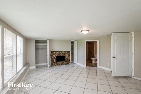 a living room with a tile floor and a fireplace