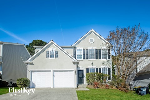 a white house with a white garage door