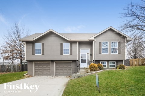 A two-story house with a garage is for sale.