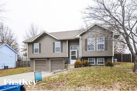 A two-story house with a garage is for sale.
