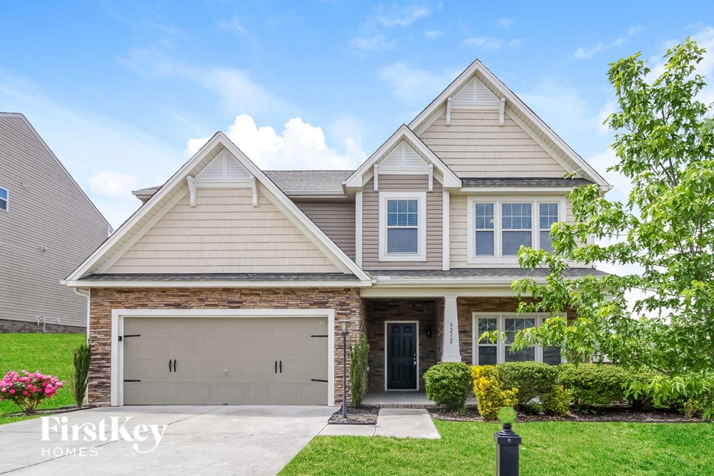 A house with a garage and a front yard.