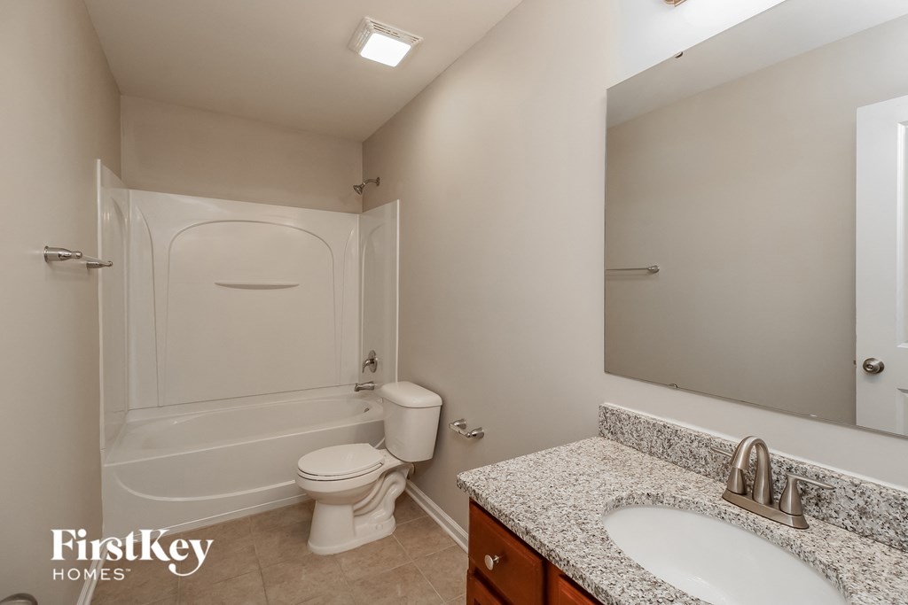 A bathroom with a white toilet and a sink.