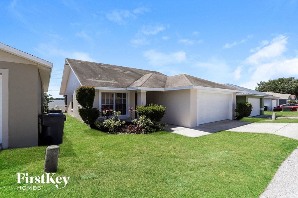 A house with a well-kept lawn and a clear sky above.
