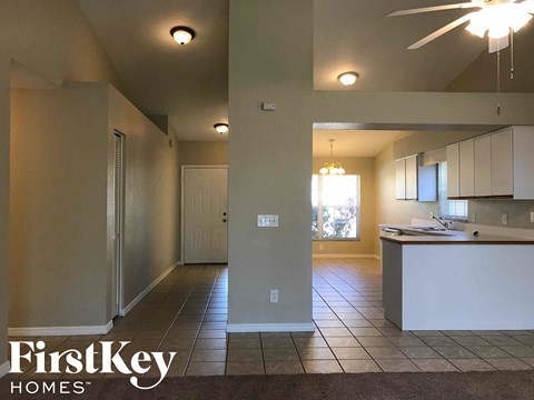 A kitchen area with a counter and a fan.