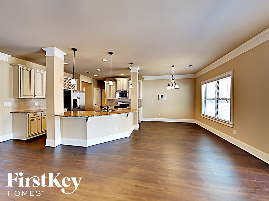 an open kitchen and living room with a large window