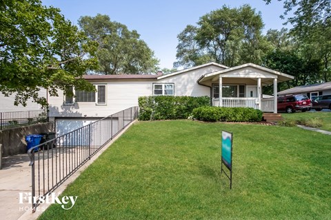 A house with a sign that says "First Key" in front of it.