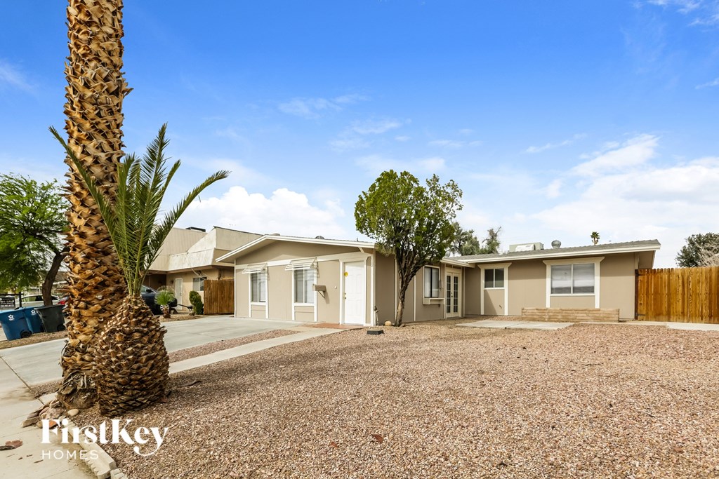 A palm tree stands in front of a house with a sign that says "FirstKey Homes".