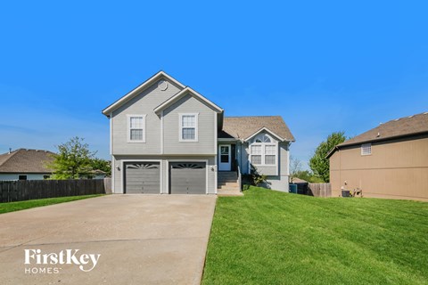 A two-story house with a garage is for sale.