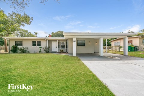 A house with a white exterior and a garage is for sale.