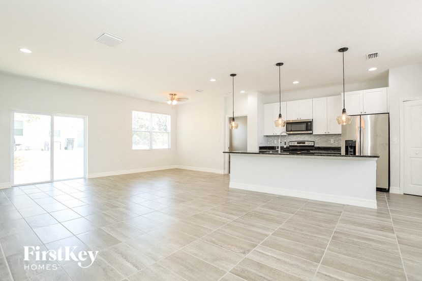 an empty kitchen and living room with a counter top