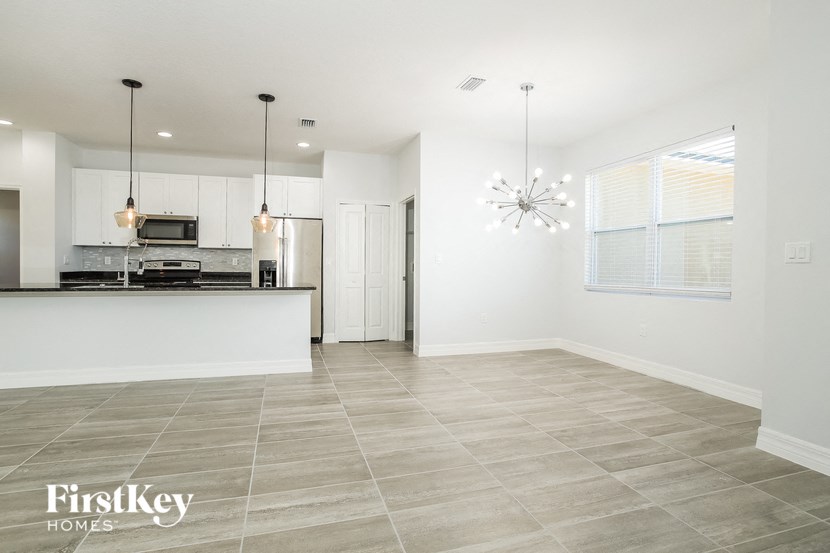 an empty kitchen and living room with a counter top