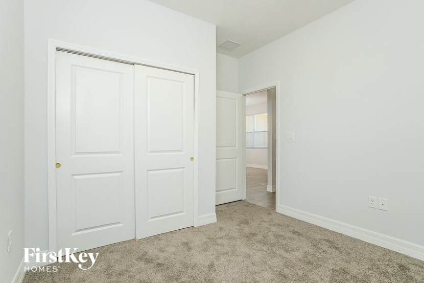a bedroom with two closets and a door to a hallway