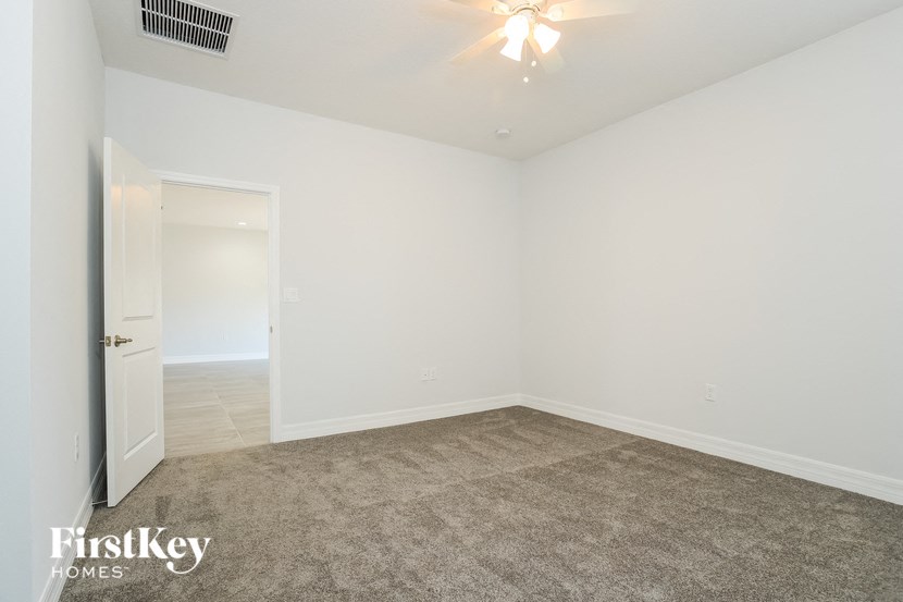 an empty living room with white walls and carpet