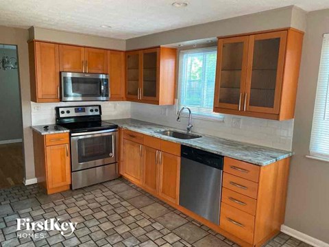a kitchen with wooden cabinets and stainless steel appliances