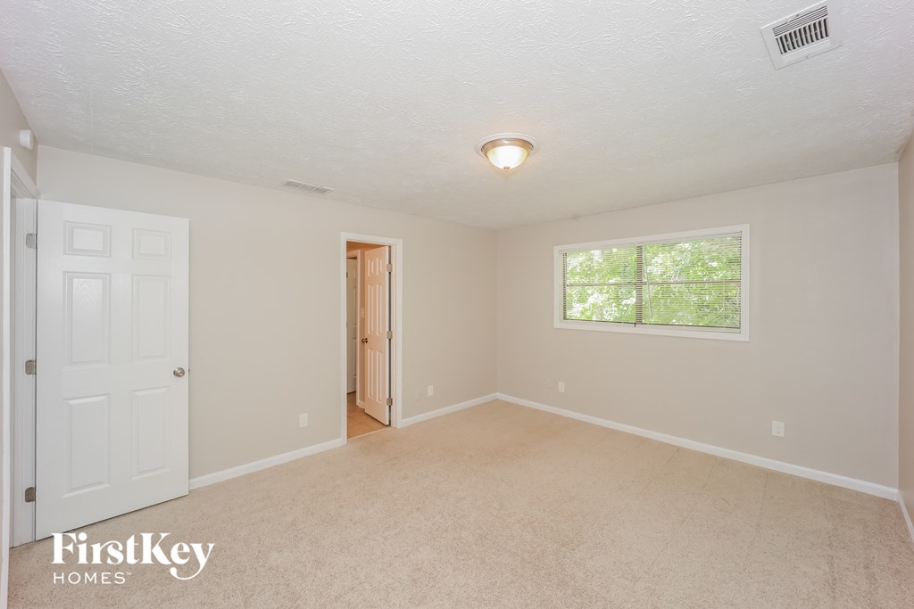 the master bedroom is spacious and updated with carpeting and a large window