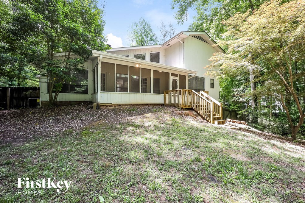 a white house with a yard and trees