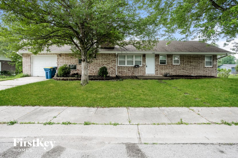 A house with a tree in front of it.