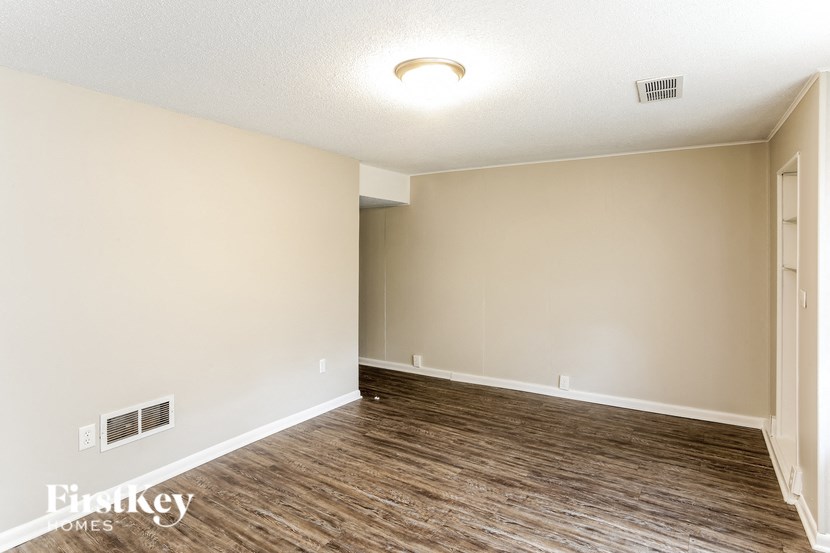 A room with wooden flooring and a light on the ceiling.