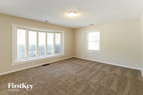 an empty living room with a view of the city