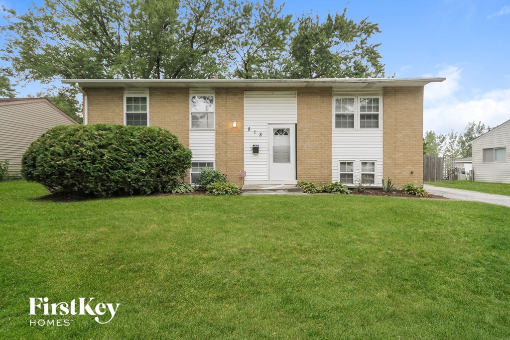 a brick house with a lawn in front of it