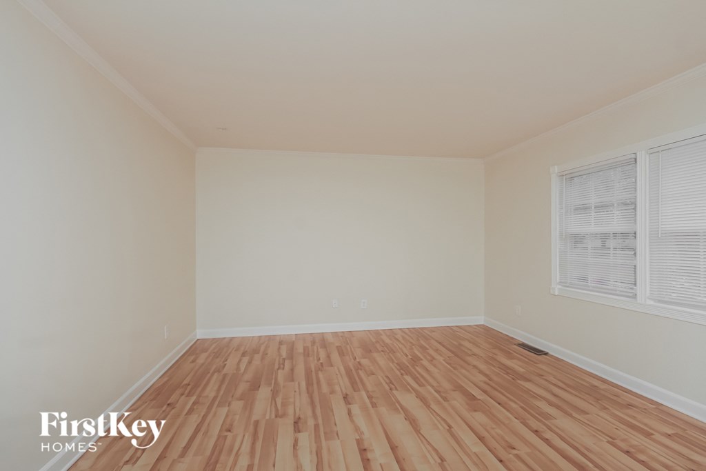the living room of an empty house with wood floors