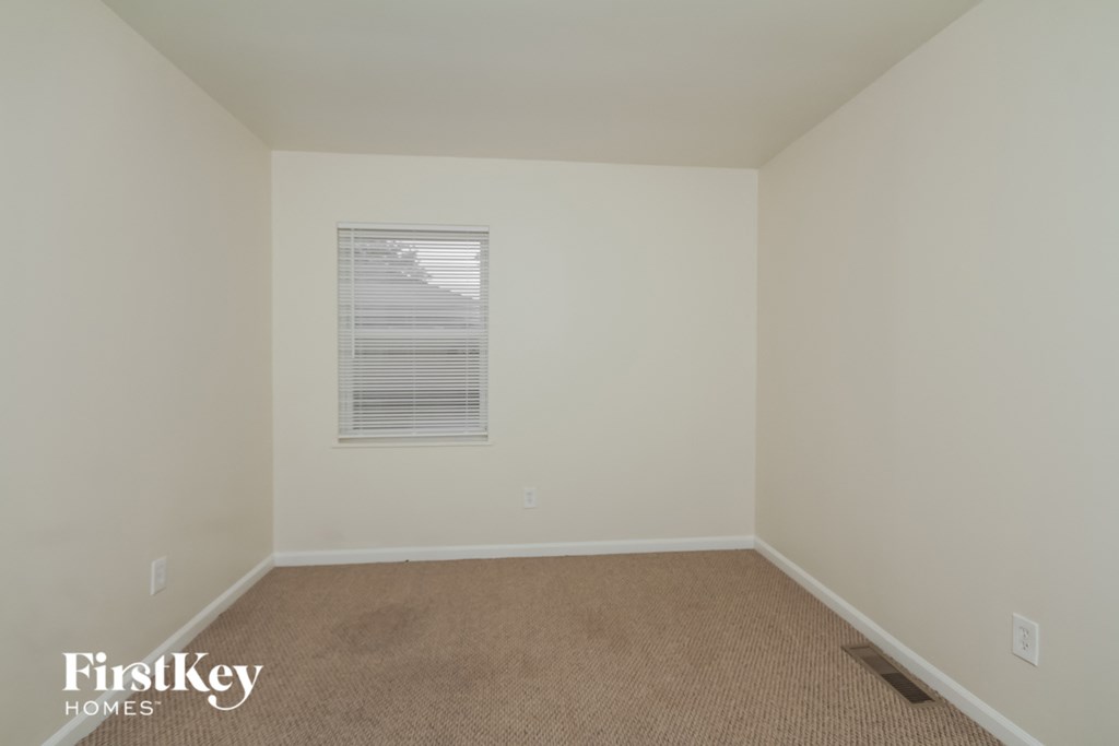 a empty room with white walls and a window