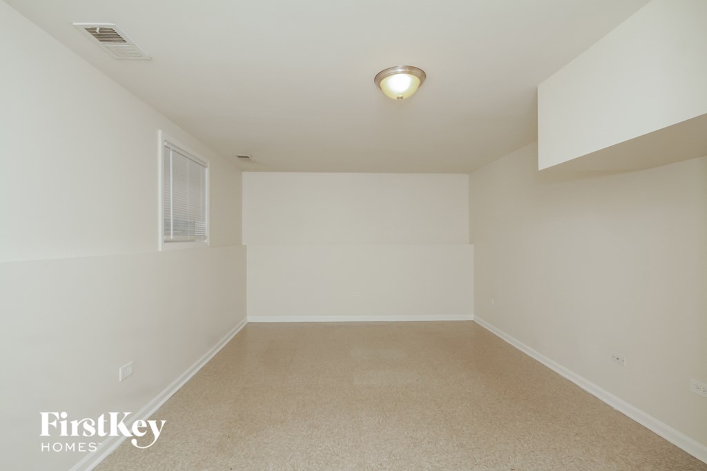 a empty room with white walls and a window