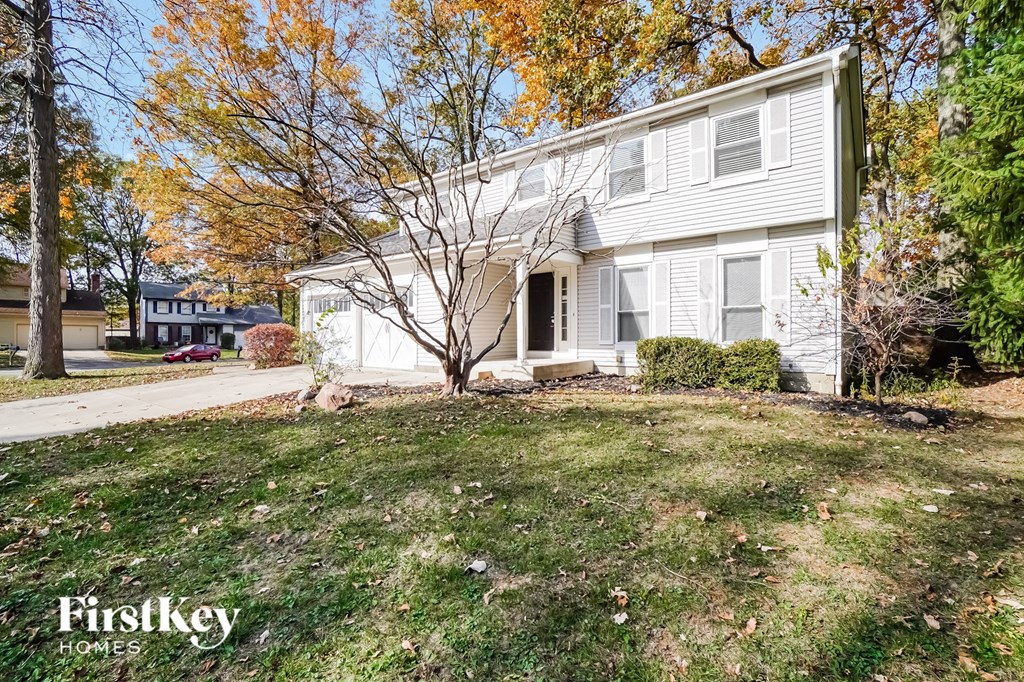 a white house with a yard in front of it