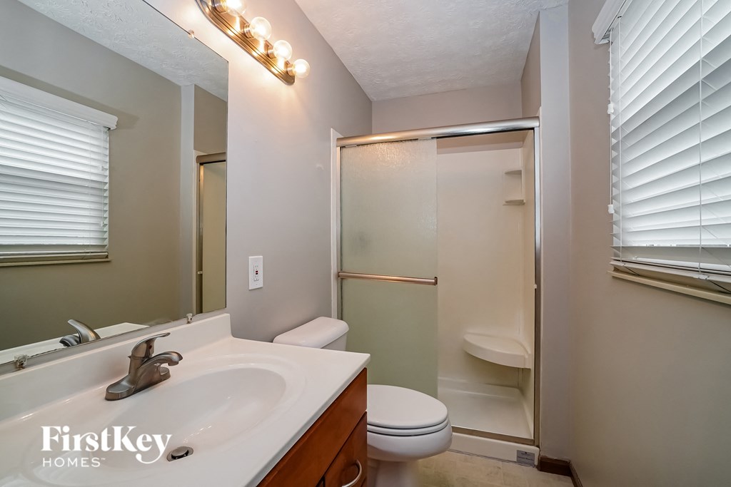 a bathroom with a sink toilet and a shower