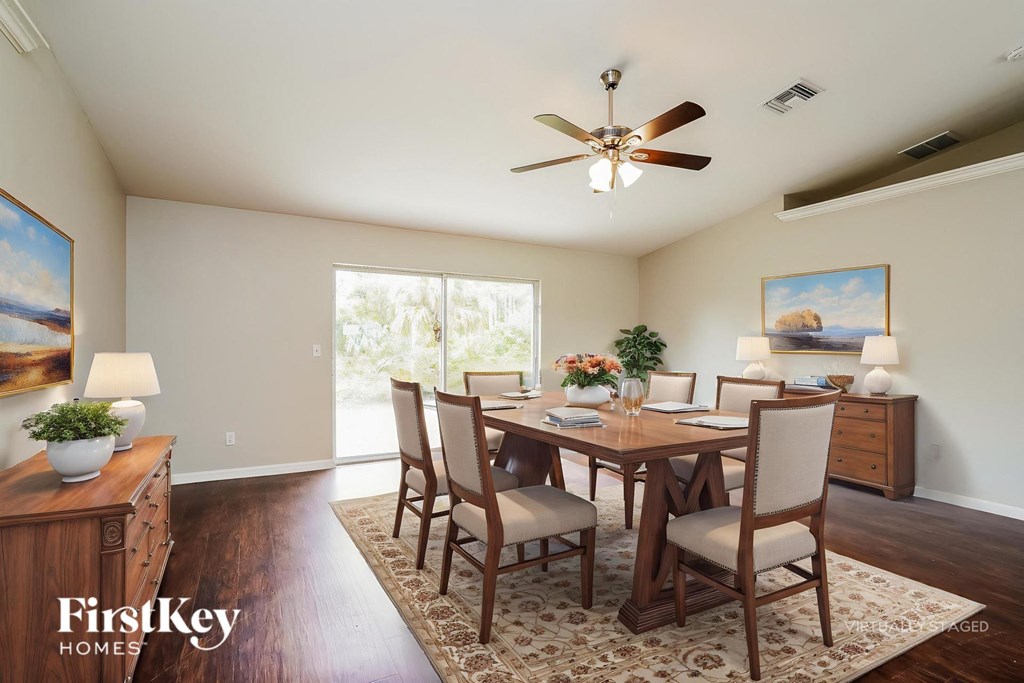 A dining room with a wooden table and chairs.