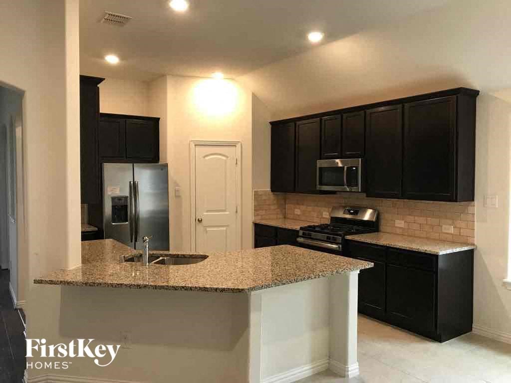 a kitchen with black cabinets and a counter top