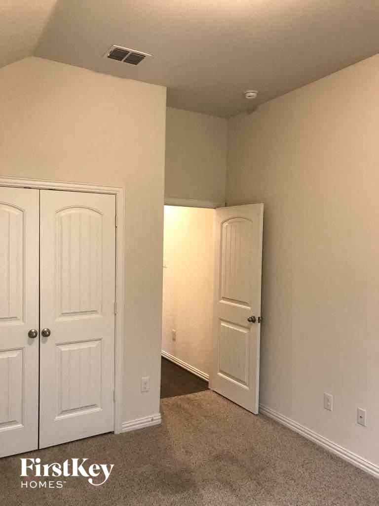 a bedroom with two closets and a door to a hallway