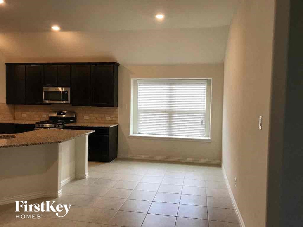 an empty kitchen with a sink and a window