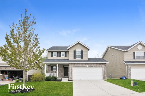 A house with a tree in front of it and the words "FirstKey Homes" on the bottom left.