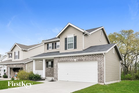 A house with a garage and a driveway is for sale by FirstKey Homes.
