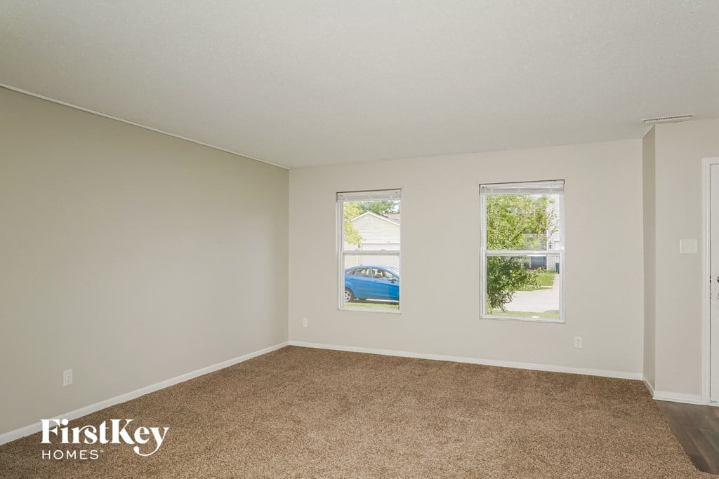 A room with a car parked outside the window.