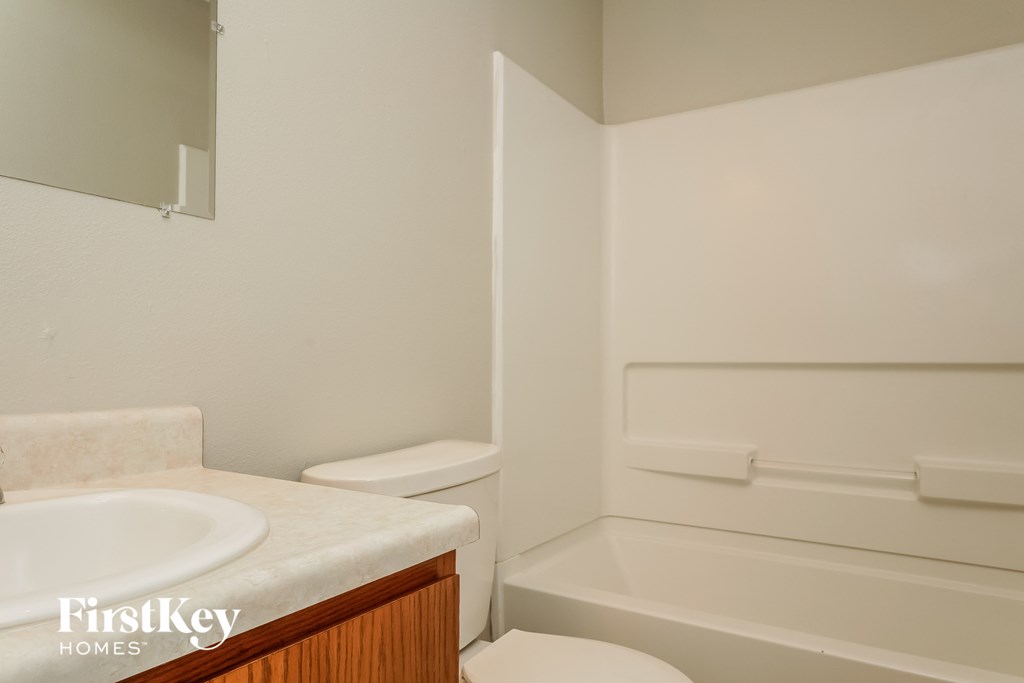 A white toilet sits next to a sink in a small bathroom.