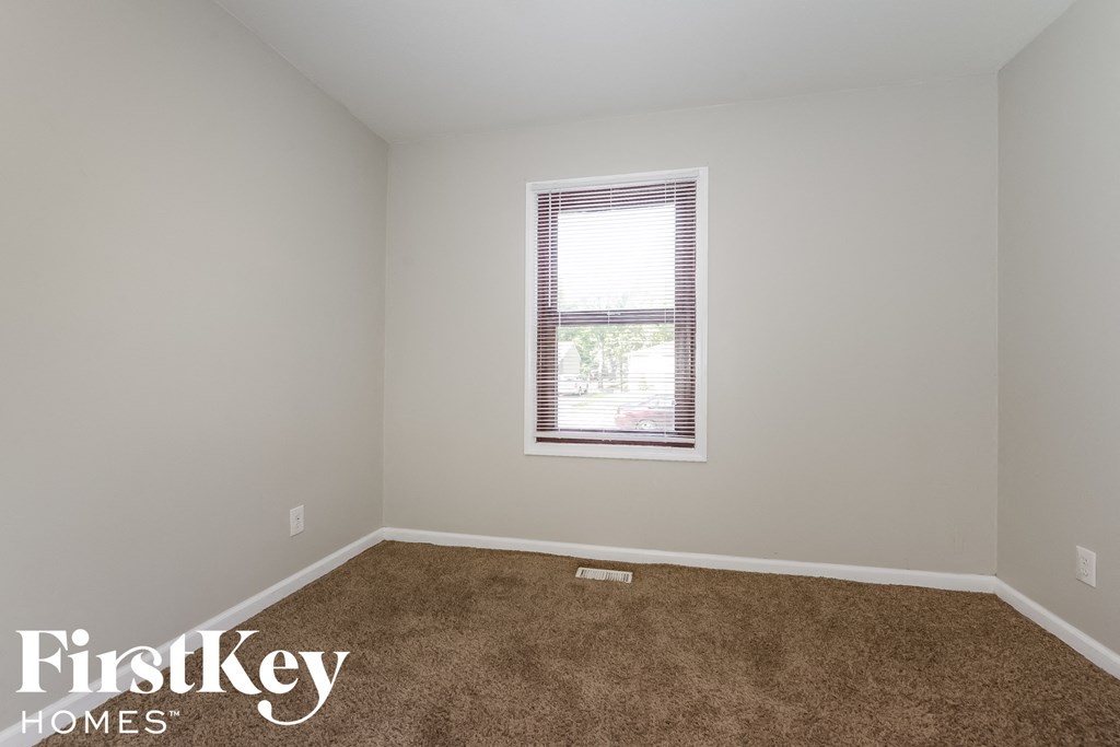 a room with a carpeted floor and a window