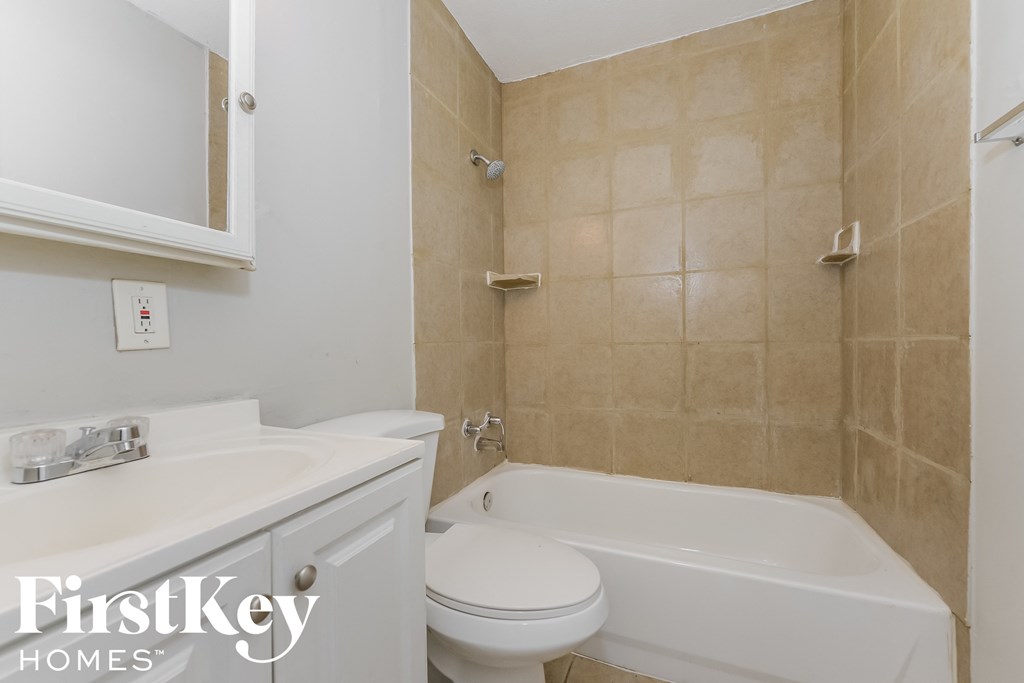 a bathroom with a sink toilet and a bath tub