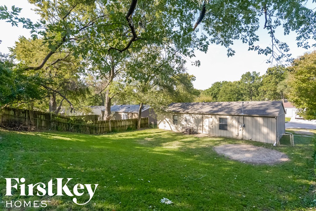 a backyard with a shed and a yard and trees