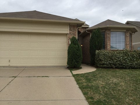 a house with a sidewalk and a garage door