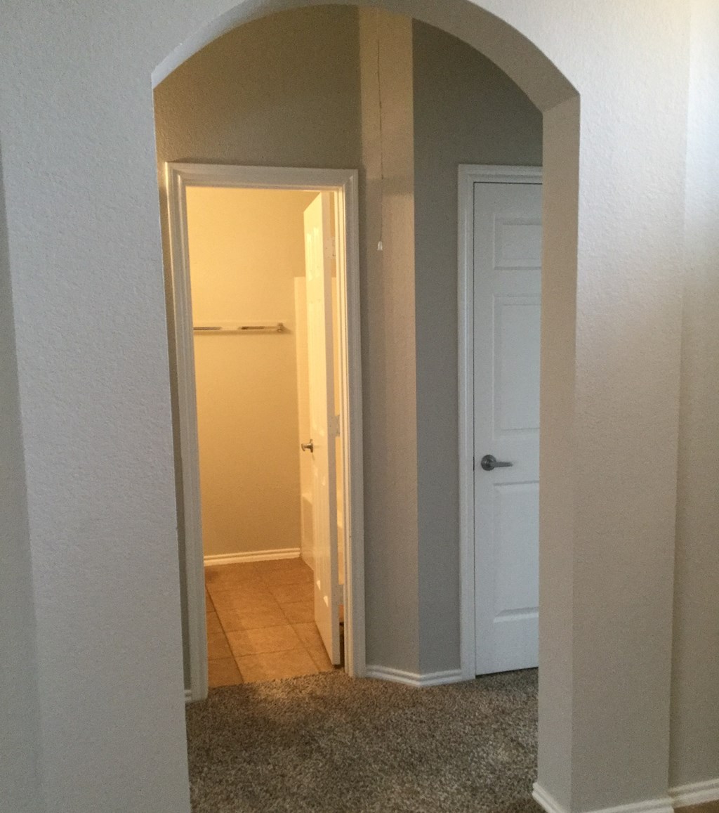 the view of the hallway from the living room into the closet