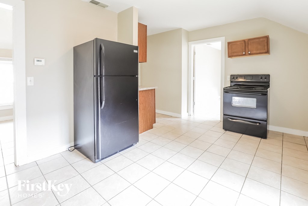a kitchen with a refrigerator and an oven in it