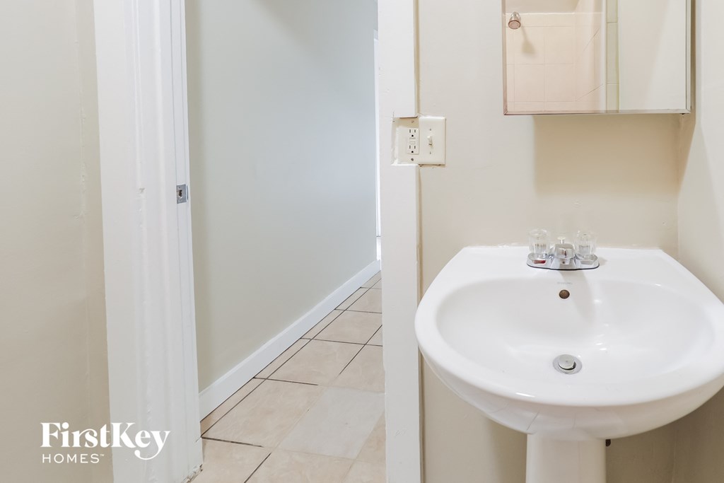 a small bathroom with a sink and a shower