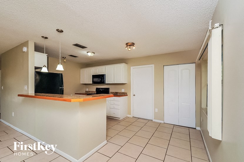 a kitchen with white cabinets and a counter top