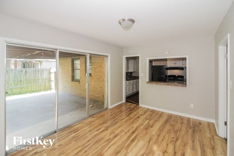 a living room with a wood floor and a sliding glass door