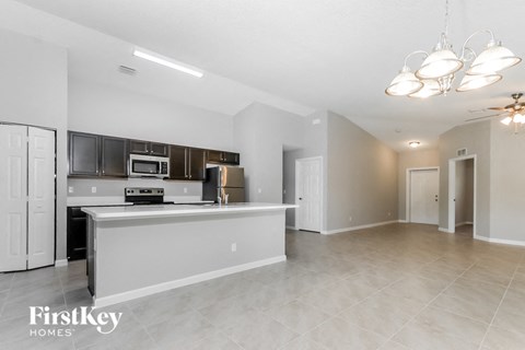 A spacious kitchen with a large island and a microwave above it.