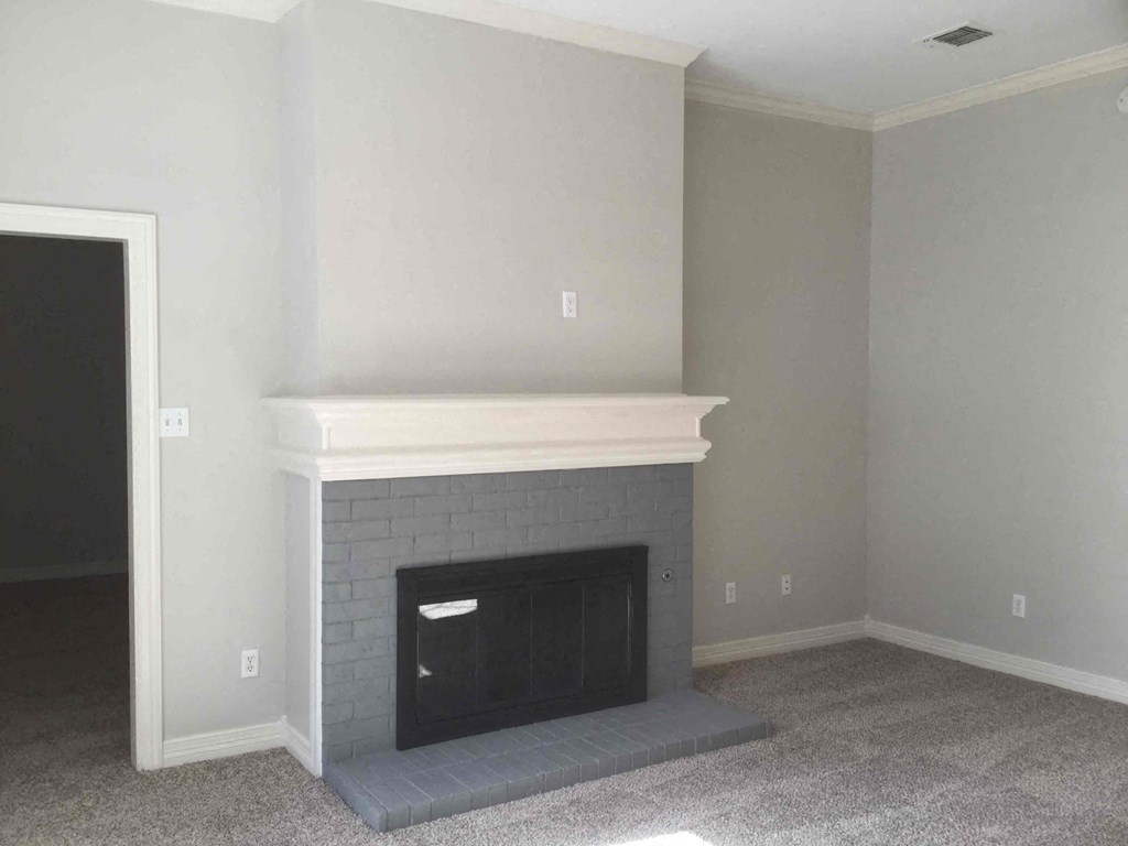 a living room with a fireplace and a door